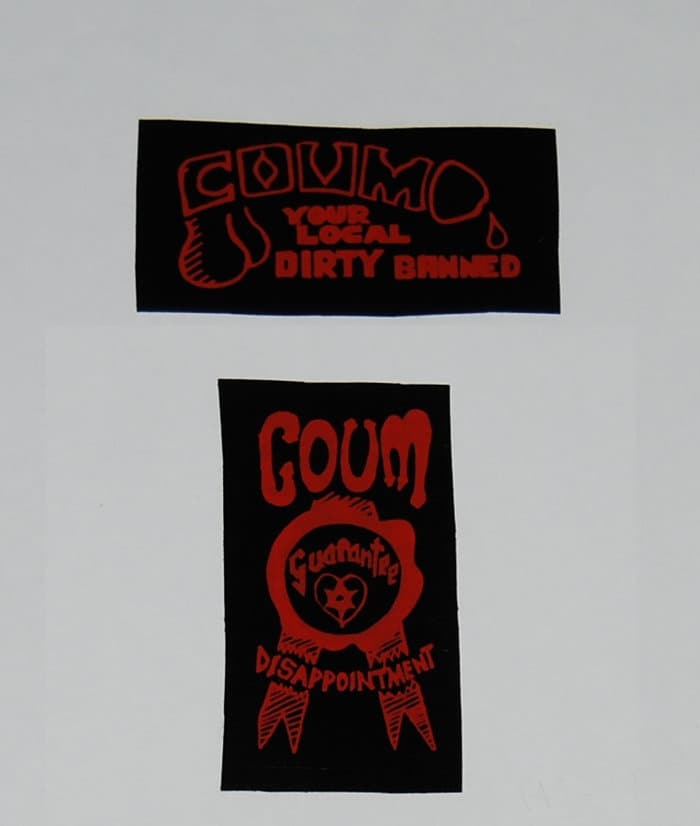 Stickers: "COUM YOUR LOCAL DIRTY BANNED" and COUM "Guarantee Disappointment"
